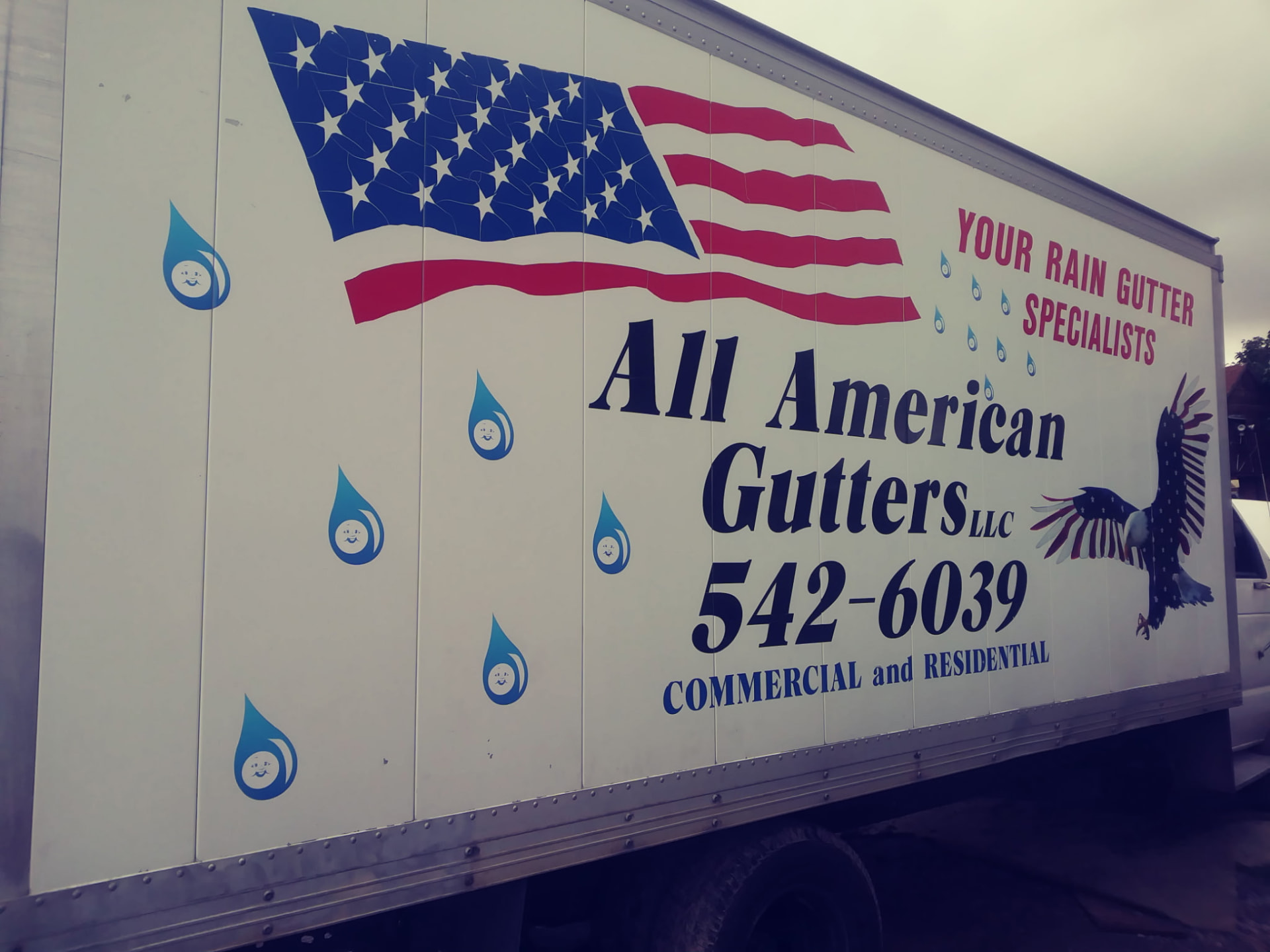 Close-up of the All American Gutters truck lettering — Your Rain Gutter Specialists, commercial and residential